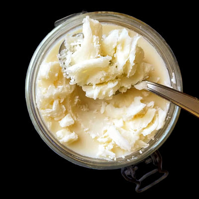 CReamy beef tallow on a wooden kitchen table close up
